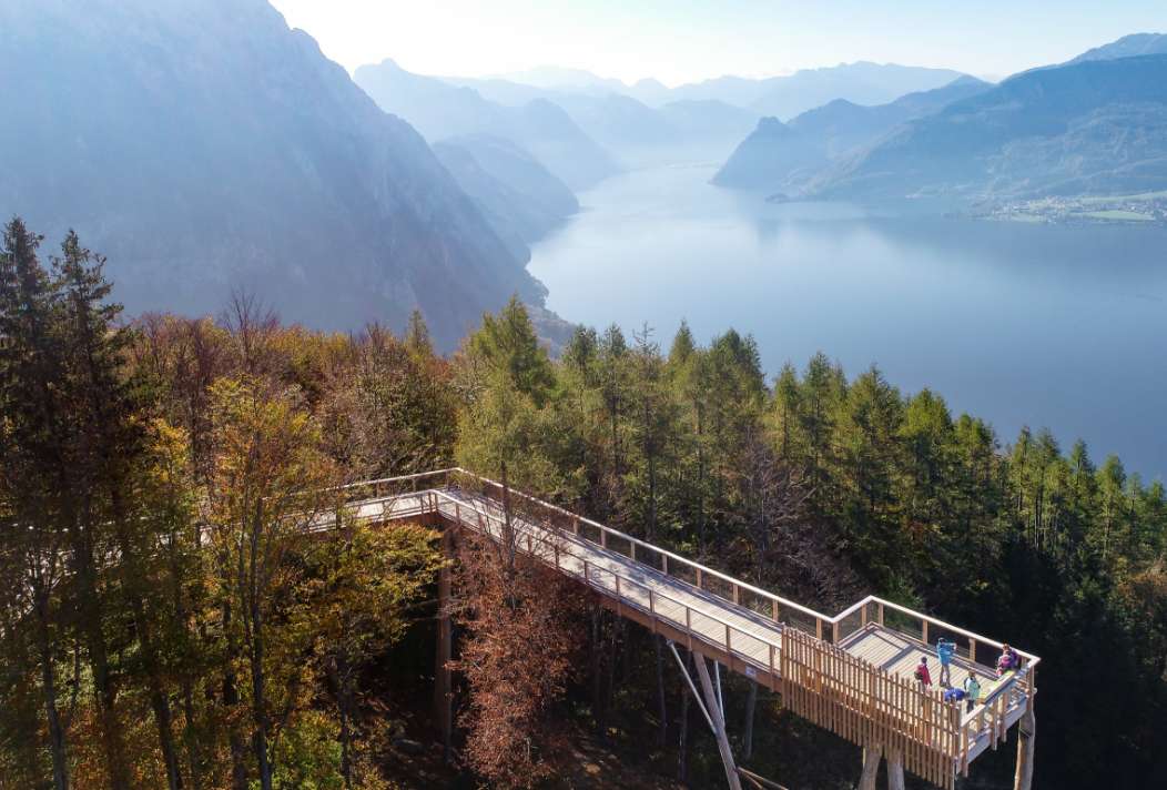 The viewing platform above the treetops with a view of Lake Traunsee and the Dachstein Mountains