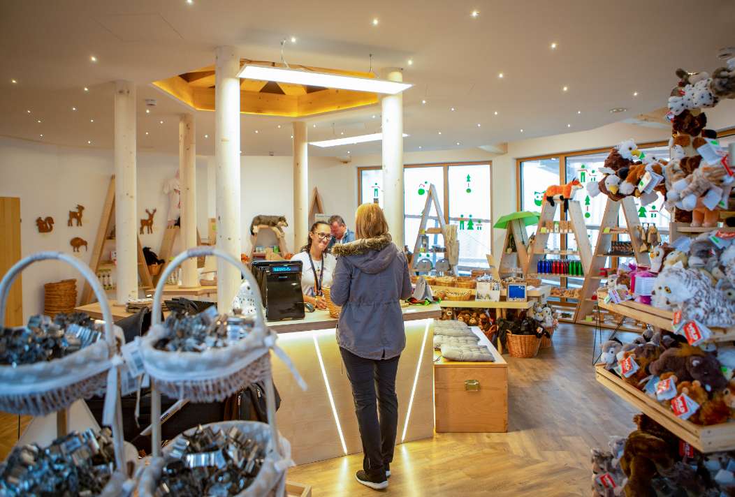 Customer buys a souvenir in the shop of the treetop path in the Salzkammergut region