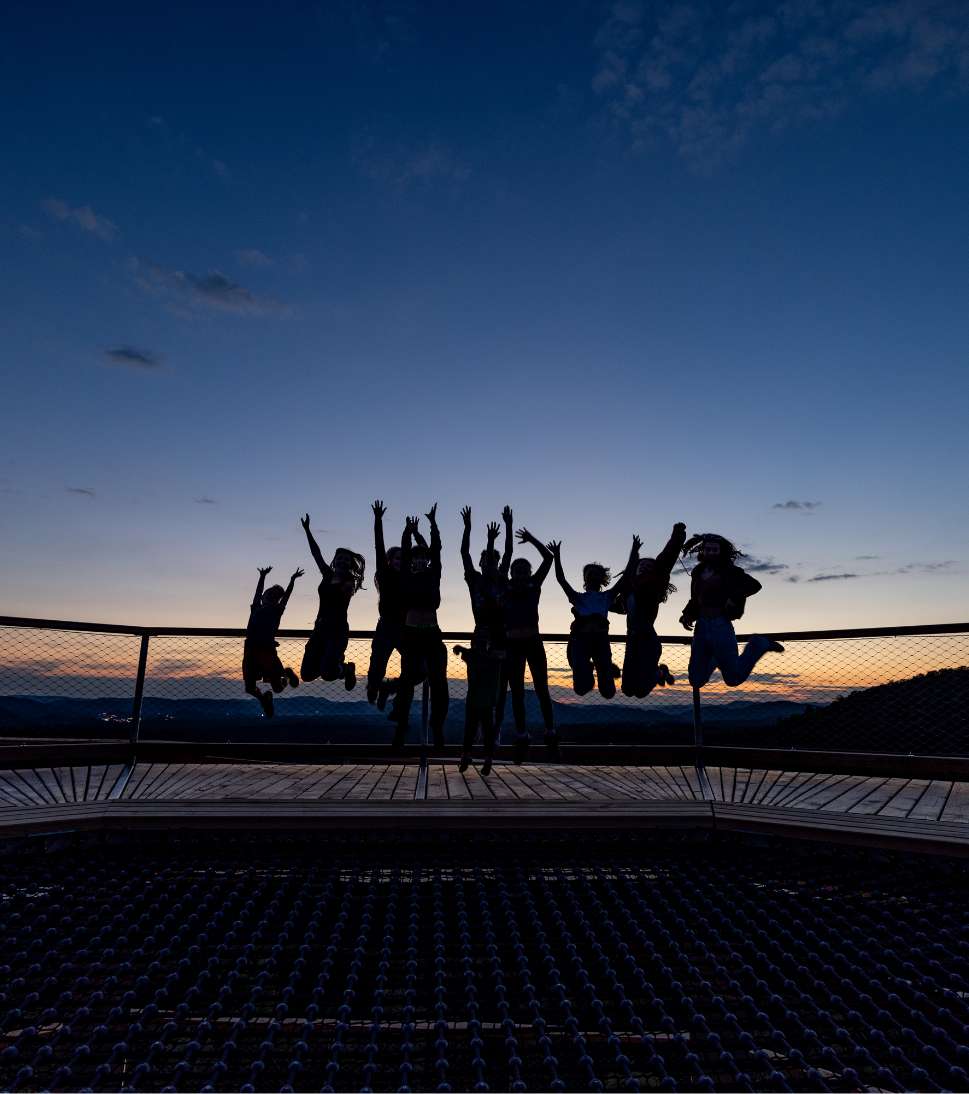 A group experiences dusk on the trail's lookout tower.