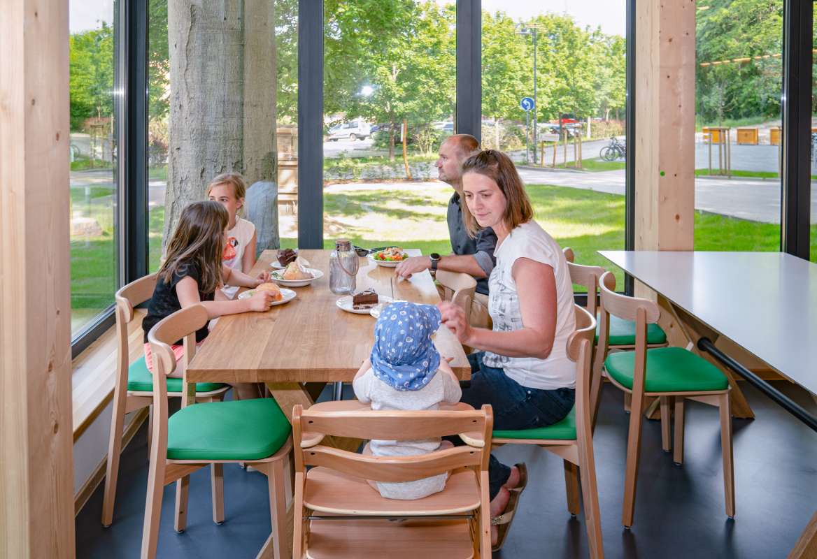 A family enjoys a meal in the self-service restaurant right at the exit of the Treetop Walk.
